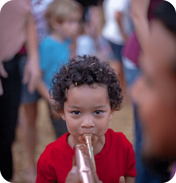 a boy blowing trumphet